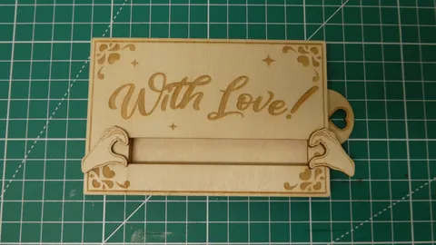 Laser engraved sliding wood gift card holder with heart hands design.