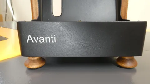 Close up of laser engraved Avanti brand name text on a textured black powder coated metal surface.