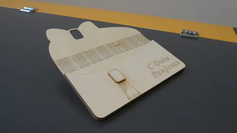 Opened custom wooden gift pouch displaying the internal latch mechanism and horizontal hinge lines.